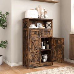 a wooden cabinet with doors and drawers in a living room next to a potted plant