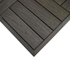 a close up view of the top of a wooden decking board with dark wood grains