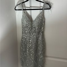 a dress hanging on a hanger in front of a door