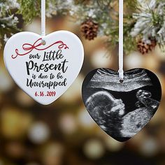 two heart shaped ornaments hanging from a christmas tree