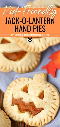 jack o'lantern hand pies on a blue cloth with an orange maple leaf