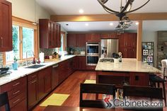 a large kitchen with wooden cabinets and stainless steel appliances