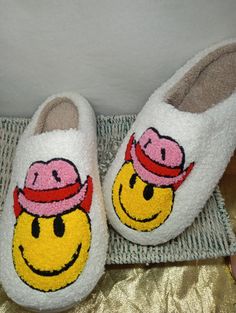 Stay cozy and put a smile on your face with these Smiley Face House Slippers! These slippers will keep your feet warm and provide you with hours of comfort. Slip them on and have fun! Get ready to embrace the joy of a smiley face. Cute Round Toe Slippers For Leisure, White Casual Slippers For Lounging, Casual White Slippers For Lounging, Casual White Lounging Slippers, White Winter Home Slippers, Playful Winter Slip-on Slippers, Fun Round Toe Winter Slippers, Fun Round Toe Slippers For Winter, White Casual Slippers