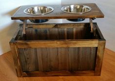 two metal bowls sit on top of a wooden stand