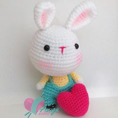 a small crocheted bunny holding a heart