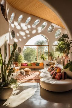 a living room filled with lots of furniture and plants