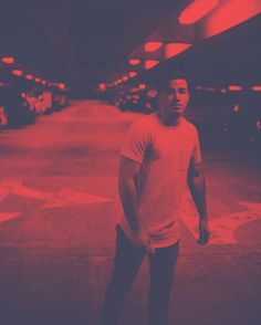 a man standing in an empty parking garage