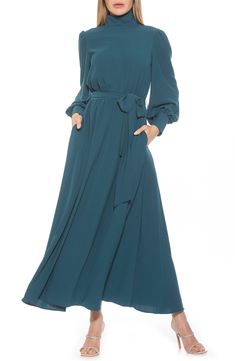 The Saliah mockneck blouson sleeve maxi dress is a classic staple piece for your wardrobe. This maxi dress features mockneck with shirring detail, dramatic blouson sleeves, elastic waist with waistband, and full maxi skirt. 55.5" length (size 4) Mock neck Back closure Long blouson sleeves Allover floral print Lined 97% polyester, 3% spandex Machine wash Imported Model stats: 5'10" height, 32" bust, 25" waist, 36" hip. Model is wearing size 4 Full Maxi Skirt, Blouson Sleeve, Midaxi Dress, Blue Dress Casual, Sleeve Maxi Dress, Dress With Tie, Maxi Dress With Sleeves, Full Skirt, Flare Skirt