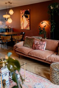 a living room filled with lots of furniture next to a dining room table and chairs