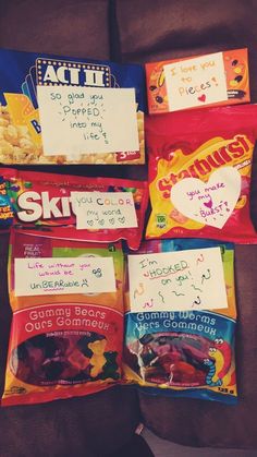 four bags of snacks with writing on them