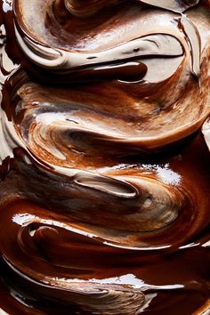 melted chocolate swirls on top of each other in brown and white colors, as if they were melting