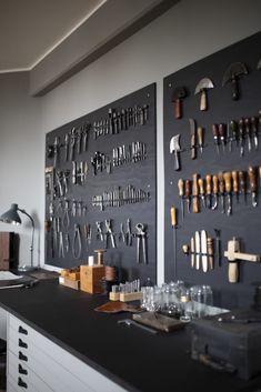 there are many tools hanging on the wall