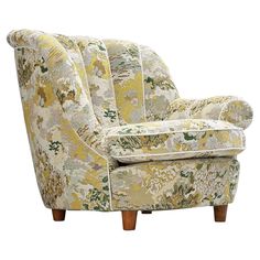 an upholstered chair with floral fabric and wooden legs, on a white background