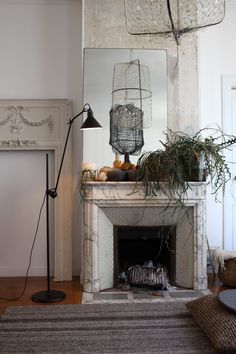 a living room filled with furniture and a fire place next to a mirror on the wall