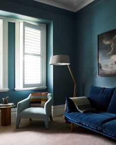 a living room with blue walls and furniture