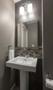 a white sink sitting under a bathroom mirror