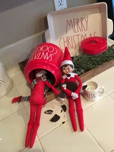 two elfs are sitting on the kitchen counter