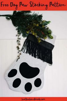 a christmas stocking hanging from the side of a door with black and white paw prints