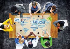 people sitting around a table with the word planning written on it in front of them