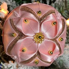 a pink ornament hanging from a christmas tree