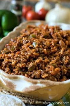 a bowl filled with rice and meat on top of a table