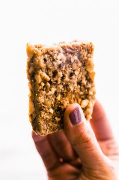 a person holding up a piece of food in their hand