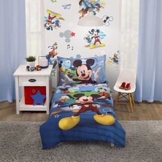 a child's bedroom with mickey mouse bedding