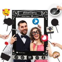 a man and woman standing in front of a photo booth with emoticions surrounding them