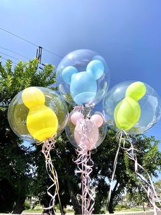 some balloons are in the shape of mickey mouse