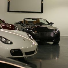 three different colored sports cars in a showroom