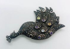 Large magnificent vintage sterling silver gemstone PEACOCK brooch. Heavy sterling silver metal in a large peacock design with marcasites and set with real gemstones. Peridot,amethyst,two colors of topaz and garnets. My pictures do. It do this beauty justice at all. Lovely beaded edged openwork in the feathers. Fully marked and acid tested as sterling silver. Measures 2 7/8 inches tall by 1 7/8 inches wide. Weighs 23gms. In excellent vintage condition condition with minimal age appropriate wear. Peacock Brooch, Interchangeable Earrings, Sterling Silver Owl, Vintage Designer Jewelry, Vintage Fine Jewelry, Peacock Design, Vintage Designer, Gorgeous Necklaces, Designer Jewelry