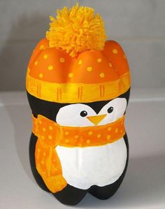 a penguin wearing a hat and scarf with an orange pom - pom on its head