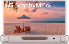 an open laptop computer sitting on top of a sandy beach with two chairs and an umbrella