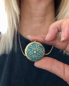 This lovely hand painted blue floral locket is the perfect gift for someone special in your life.  The locket is quite substantial but not so huge it is cumbersome.  This locket works well with family group photos as the photo area is large enough to see the faces of a group.  The locket is made from raw brass and the embossed flower almost takes up the whole front of the locket face.  The locket is strung on a golden brass rolo chain and is finished off with a lobster clasp.  You choose your length of chain at checkout. You can choose to add your own photos to the locket or have us customize it for you with either regular or resin coated photos. This makes a wonderful gift for Mom or Grandma for Mother's Day ,  Something blue for your wedding day, a memorial locket for the loss of a loved Blue Engraved Jewelry For Keepsake, Blue Hand Painted Jewelry Gift, Hand Painted Blue Jewelry For Gifts, Blue Hand Painted Jewelry As A Gift, Blue Hand Painted Jewelry For Gift, Blue Medallion Locket Necklace As Gift, Blue Engraved Necklace For Keepsake, Blue Medallion Jewelry For Gifts, Blue Medallion Locket Necklace