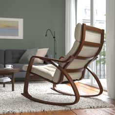 a rocking chair in a living room next to a couch