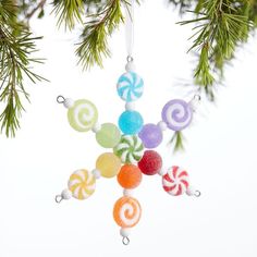 an ornament hanging from a christmas tree decorated with lollipops and candy