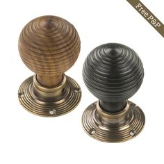 two black and gold knobs on white background