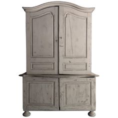 an old white cabinet with two doors and drawers on it's sides, against a white background