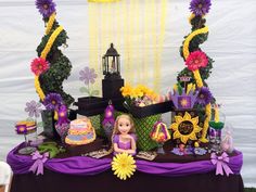 a table topped with lots of cakes and flowers next to a sign that says magic's enchanted