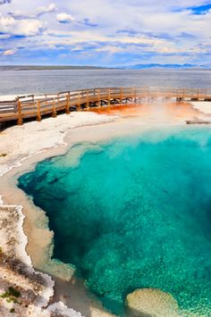 the water is very blue and green in this area with boardwalks leading to it