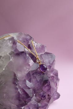 . Gemstone: Amethyst  . Gemstone Properties" Amethyst is known for its soothing properties that help relieve stress and promote calmness. . Finish: 14K Gold Plating Experience the beauty and elegance of our Amethyst Necklace, a perfect representation of your February birthstone. This dainty necklace features a stunning Amethyst pendant that is delicately handcrafted and plated with 14K gold for an exquisite finish. The pendant's unique cut highlights the gemstone's natural hues, creating a breat Purple Oval Gemstone Necklace, Oval Lavender Gemstone Necklace, Amethyst Gemstones With Spiritual Style, Spiritual Amethyst Gemstones With Accents, Spiritual Amethyst Gemstones, Amethyst Crystal Necklaces With Round Pendant, Purple Amethyst Gemstones With Accents, Oval Purple Necklaces With Natural Stones, Round Amethyst Gemstones With Accents