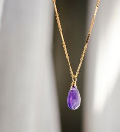 Indulge in the energy of Amethyst with this dainty necklace! Handcrafted with genuine deep purple Amethyst in a faceted teardrop shape, this crystal pendant comes on your choice of a sterling silver or 14k gold filled chain in various styles. It's perfect as bridesmaid gifts, for those born in February, or a special treat for yourself. Amethyst Meaning: Amethyst is believed to enhance passion, creativity, and spirituality. It's also said to assist with temperance and sobriety, as well as inflamm Purple Teardrop Drop Necklace As Gift, Purple Birthstone Teardrop Pendant Necklace, Gold Teardrop Amethyst Necklaces, Purple Teardrop Gemstone Necklace, Amethyst Teardrop Necklace For Healing, Purple Teardrop Birthstone Necklace, Purple Teardrop Necklaces For Jewelry Making, Purple Teardrop Necklace For Jewelry Making, Teardrop Amethyst Gemstone Necklace