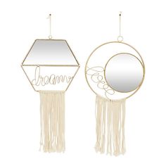 two mirrors hanging from hooks with the word dream written on them, and one has a circular