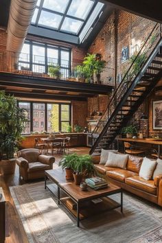 a living room filled with lots of furniture next to a stair case and large windows