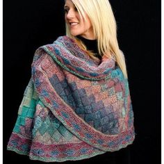 a woman wearing a multicolored knitted shawl