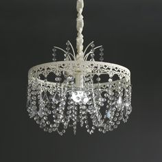 a white chandelier hanging from a ceiling