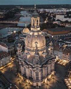 an aerial view of the dome of a building at night with lights on and around it