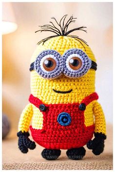 a crocheted minion sitting on top of a table