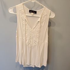 Sleeveless White Top Lightweight Cotton Never Worn Sleeveless Embroidered Spring Vest, Spring Sleeveless Embroidered Vest, Sleeveless Embroidered Vest For Spring, Spring Embroidered Sleeveless Vest, Embroidered Sleeveless Vest For Spring, Summer Sleeveless Embroidered Vest, Sleeveless Embroidered Vest For Summer, Casual Embroidered Sleeveless Vest, Casual Floral Embroidered Sleeveless Tank Top