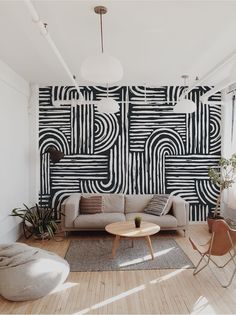 a living room with black and white wallpaper